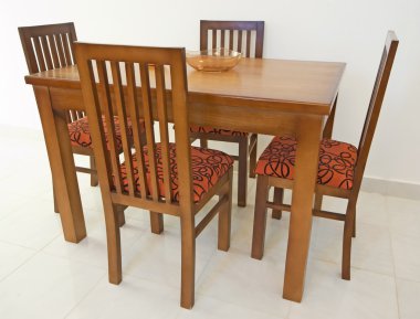 Dining table and chairs in apartment clipart