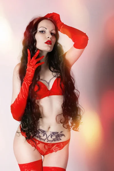 Beautiful girl in red underwear and gloves — Stock Photo, Image