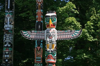 Totem Poles in Stanley Park, Vancouver Canada clipart