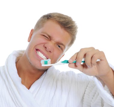 Adam dişlerini fırçalıyor.
