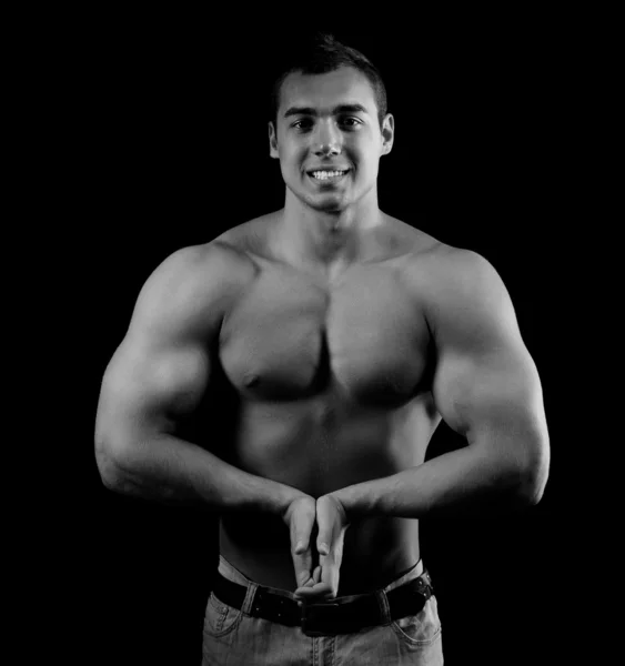 Bodybuilder zeigt seine Muskeln Stockbild