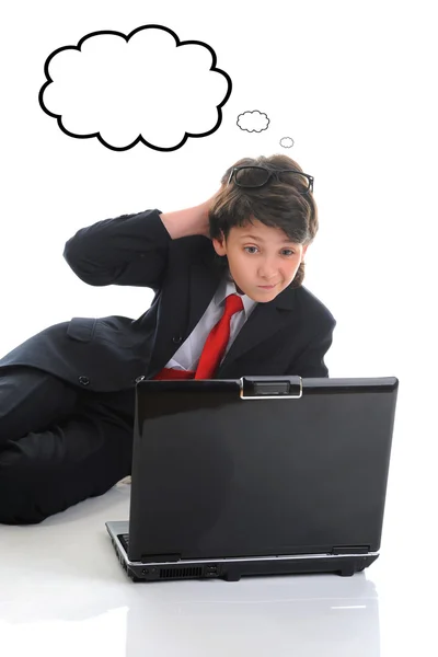 Boy in business suit sitting in front of computer Royalty Free Stock Photos