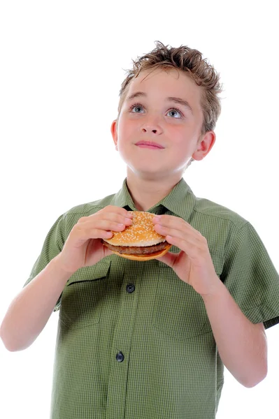 Niño comiendo una hamburguesa Imagen de stock