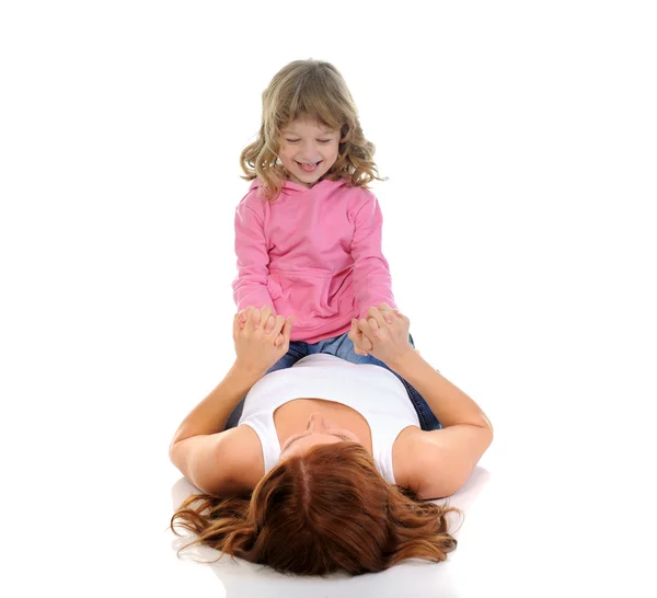 Cheerful girl hugs her young mother. — Stock Photo, Image