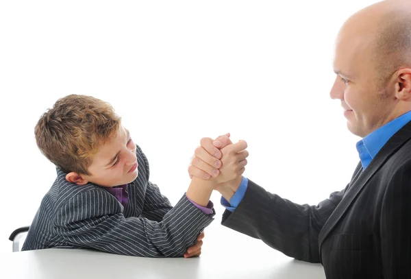 Boy and a man arm wrestling Stock Photo