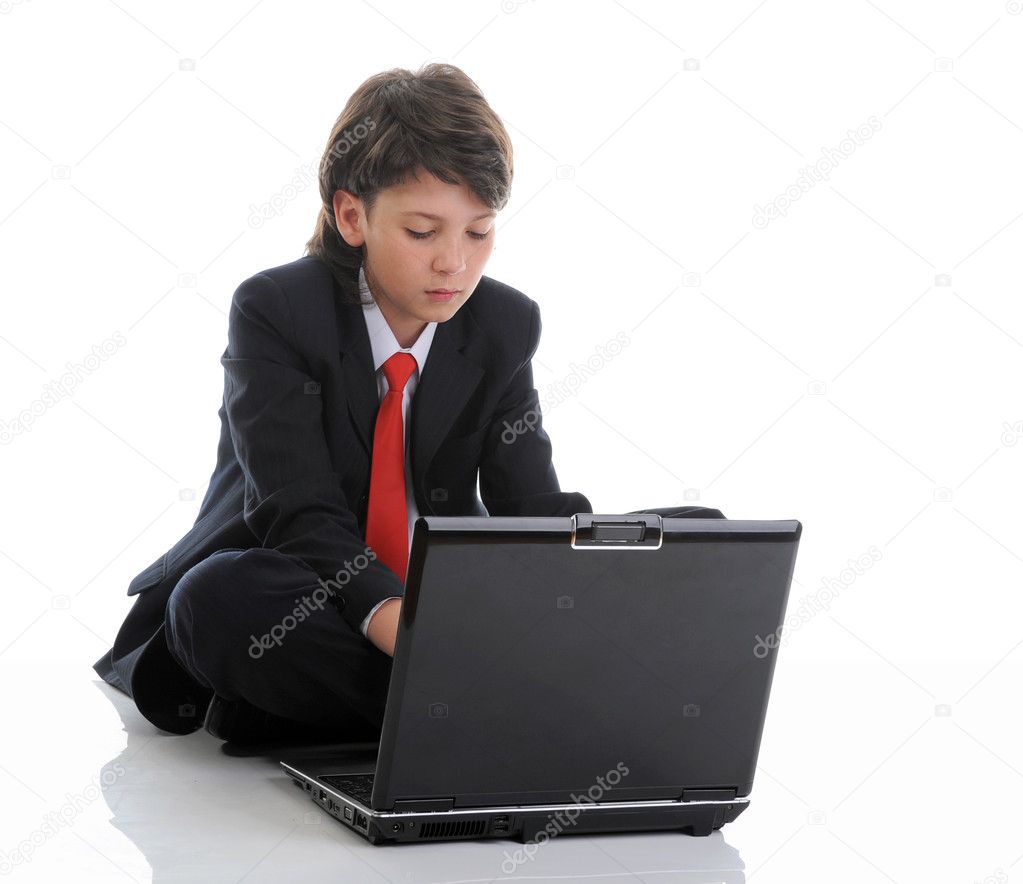 Boy in business suit sitting in front of computer