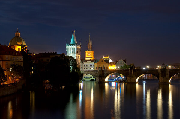 Night look on nabarezhny the Vltava Rivers and Karlov Bridge in Prague