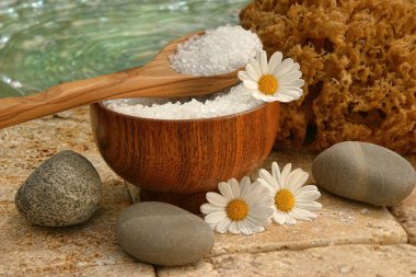 Spa still life with bath salts and daisies clipart