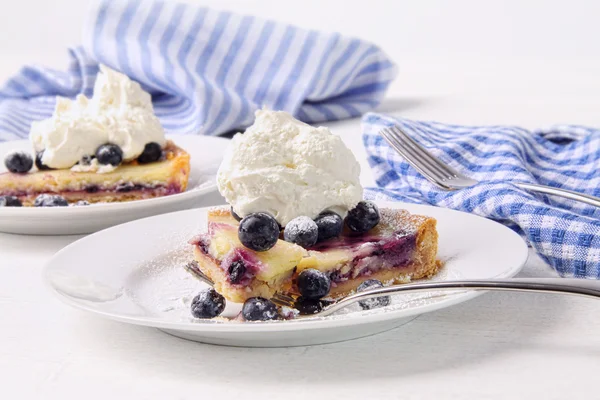 Blueberry lemon tart with whip cream on wood table — Stock Photo, Image