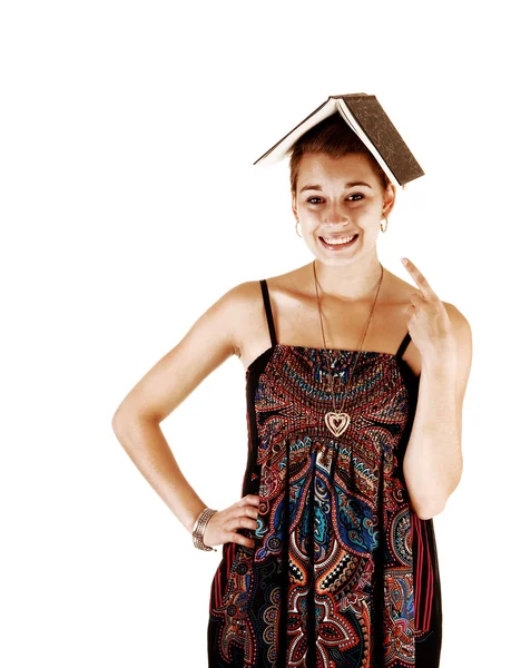 Girl with book on head. — Stock Photo, Image