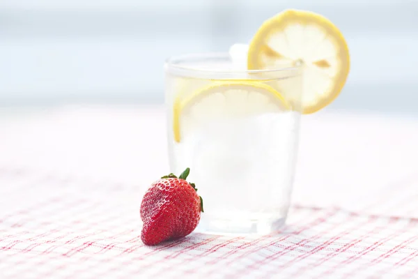 Cocktail with ice, lemon and strawberry — Stock Photo, Image