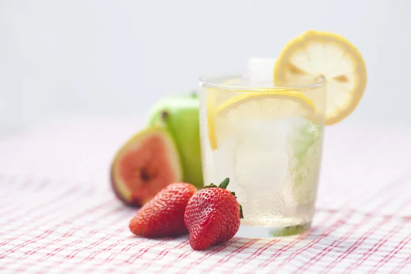 Cocktail with ice,lemon, fig,apple and strawberries — Stock Photo, Image
