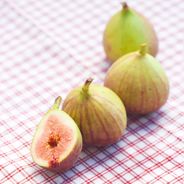 Figs lying on plaid fabric — Stock Photo, Image