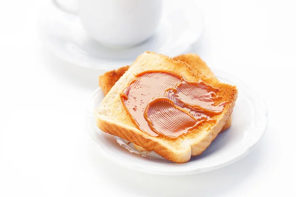 Tea and toast with caramel isolated on white — Stock Photo, Image