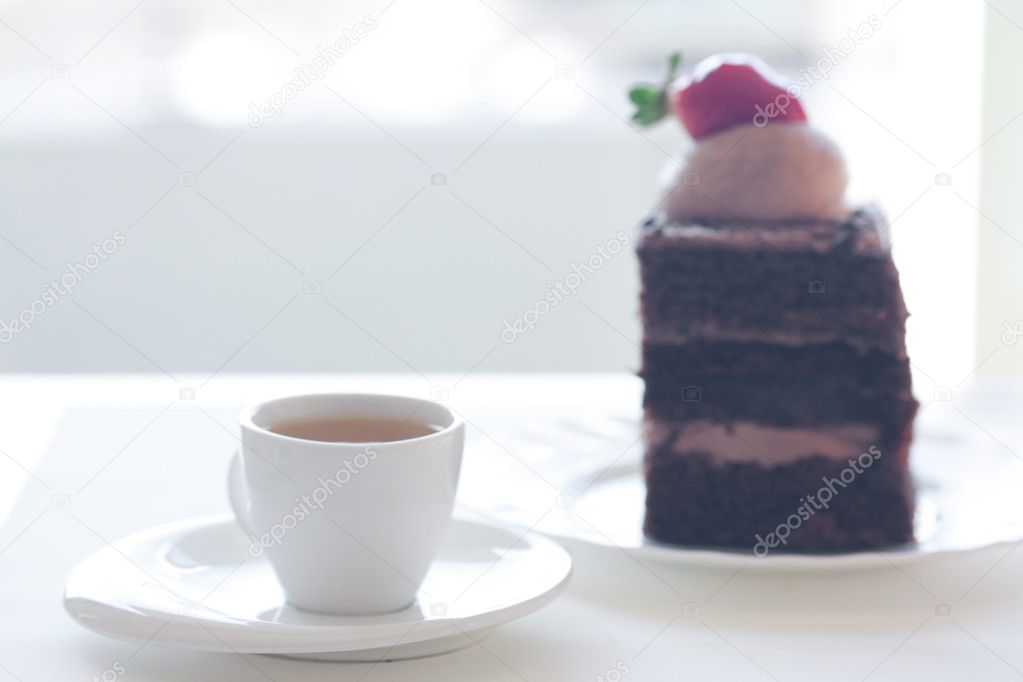 Beautiful cake with strawberry and tea on background of street