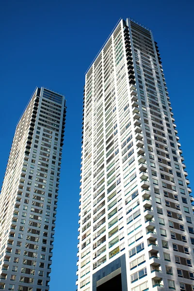 stock image Beautiful modern office building against the blue sky