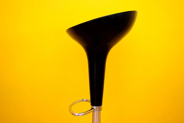 Bar chair against a yellow wall in the apartment — Stock Photo, Image
