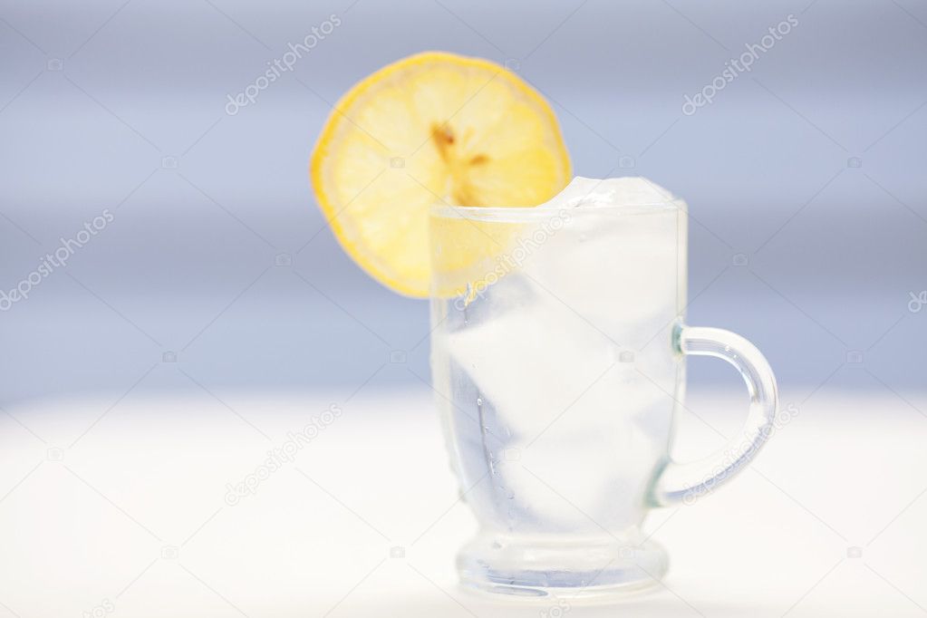 Water with lemon and lime in a glass with ice