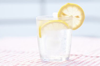 Water with lemon and lime in a glass with ice clipart