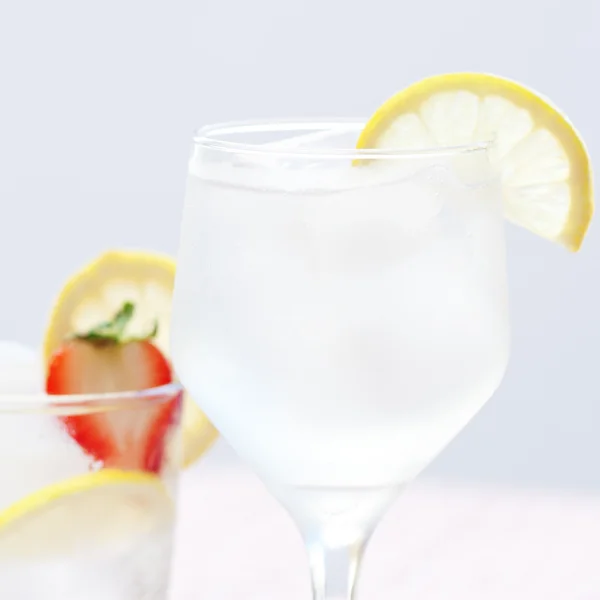 Cocktail with ice,lemon and strawberries — Stock Photo, Image