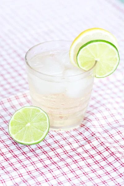 Water with lemon and lime in a glass with ice — Stock Photo, Image