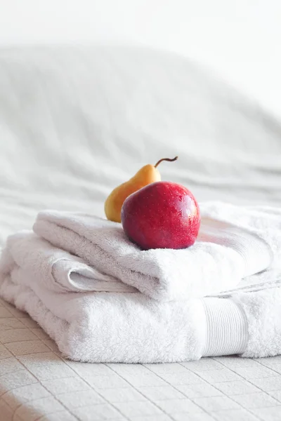 Manzana y pera sobre toallas en la cama — Foto de Stock