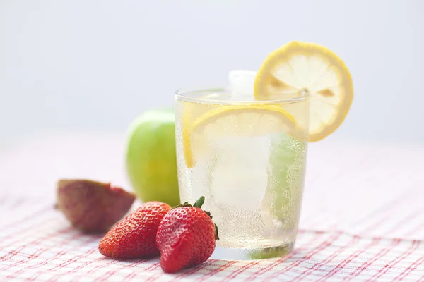 Cocktail with ice,lemon,apple and strawberries — Stock Photo, Image