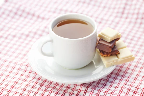 Bar of chocolate and tea on plaid fabric — Stock Photo, Image