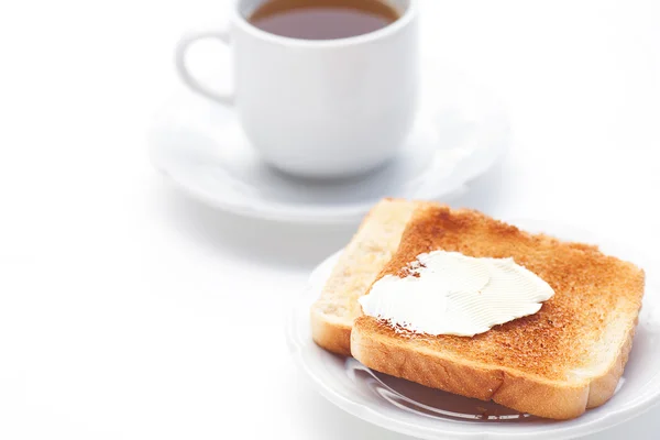 stock image Tea and toast with butter isolated on white