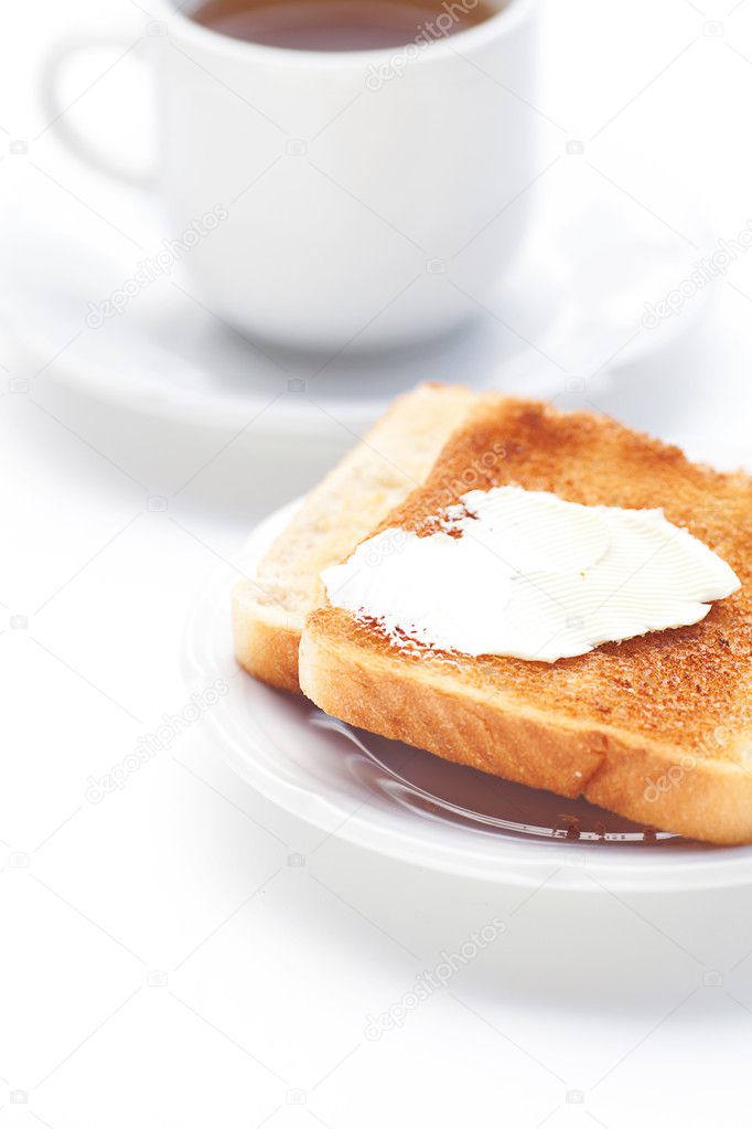 Tea and toast with butter isolated on white