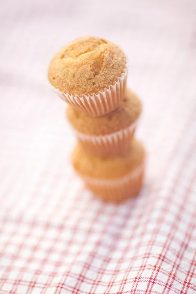 Three muffins on plaid fabric — Stock Photo, Image