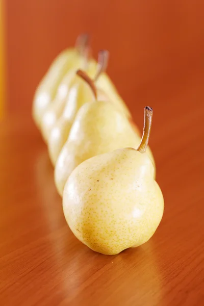 Pears lying on a wooden table — Stock Photo, Image