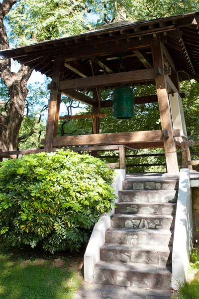 Japanese bell in the background of green trees — Stock Photo, Image