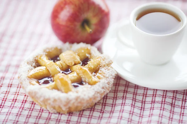 Manzana, hermoso pastel con bayas y té en tela a cuadros —  Fotos de Stock