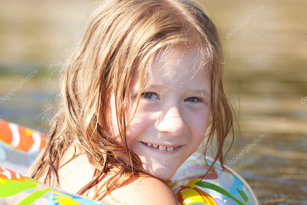 Portrait of a beautiful little girl with a color lifebuoy Stock Photo ...