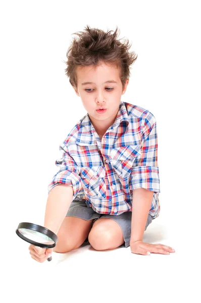 Little boy with weird hair researching using magnifier — Stock Photo, Image