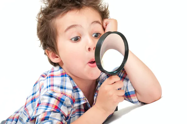 Surprised little boy with weird hair and magnifier — Stock Photo, Image