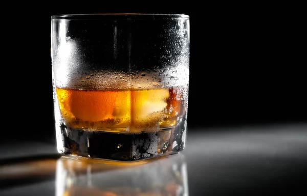 stock image Closeup misted glass of whiskey in backlight