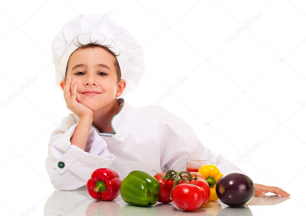 Little happy boy chef in uniform with vegatables lean on hand