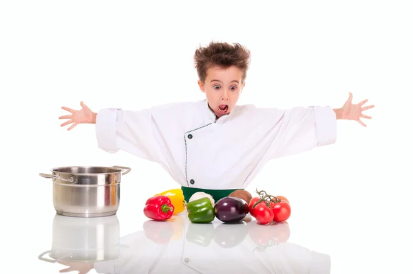 Little boy chef in uniform cooking vegatables shocked — Stock Photo, Image
