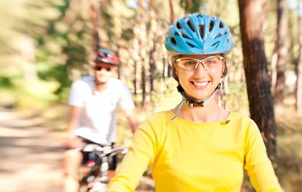 Couple on bikes in the sunny forest — Stock Photo, Image