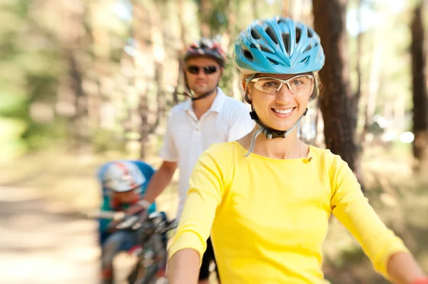 Family on the bike in the sunny forest — Stock Photo, Image