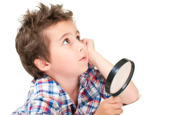 Dreamy little boy with weird hair and magnifier — Stock Photo, Image