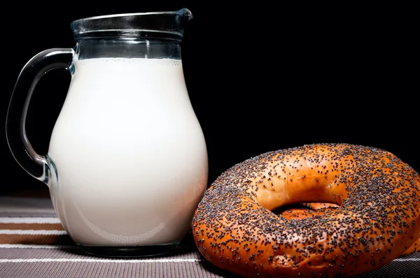 Jug of milk and poppy donuts — Stock Photo, Image