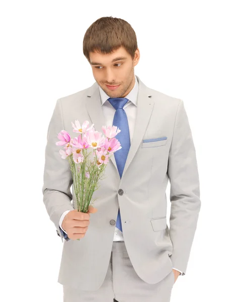 Hombre guapo con flores en la mano —  Fotos de Stock