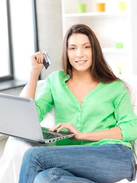 Mulher feliz com computador portátil e cartão de crédito — Fotografia de Stock