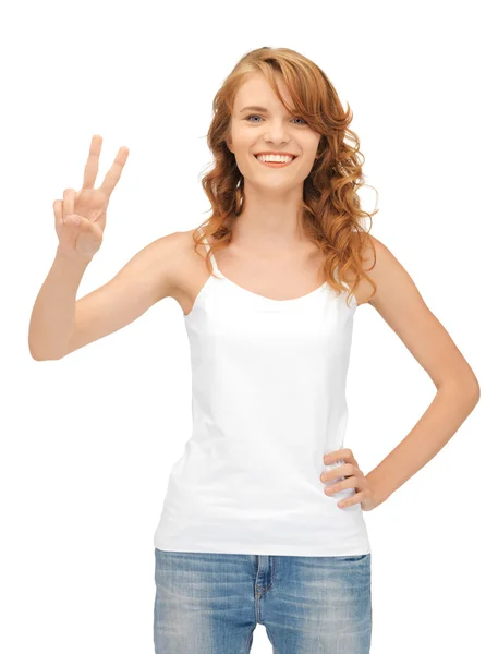 Girl in blank white t-shirt showing victory sign — Stock Photo, Image