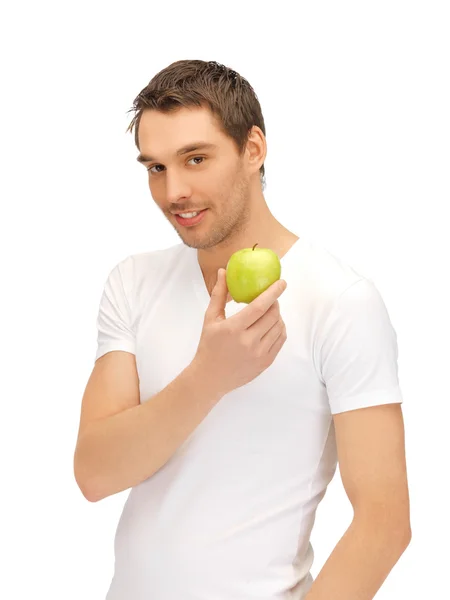 Uomo in camicia bianca con mela verde — Foto Stock