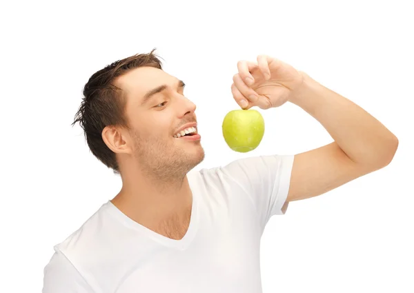 Hombre de camisa blanca con manzana verde — Foto de Stock