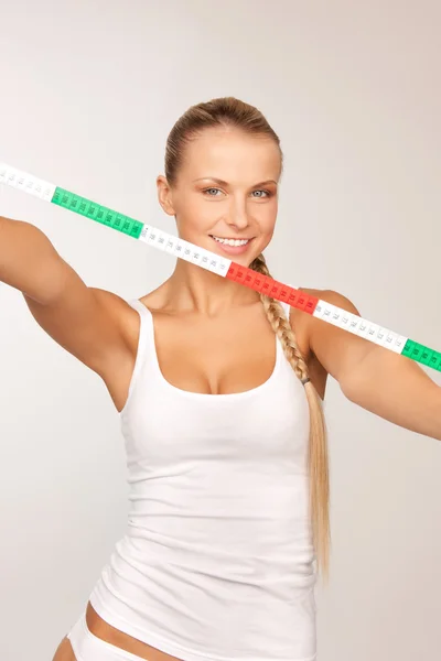 Young beautiful woman with measure tape — Stock Photo, Image